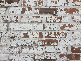 brick wall texture with peeling white paint