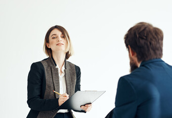 A man for an interview In a bright room talking to a woman opposite