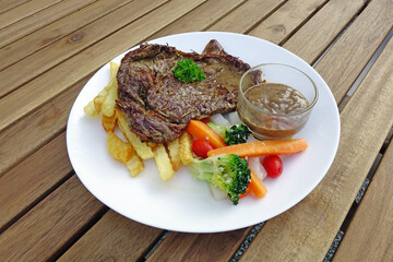 beef steak with vegetables and French fries