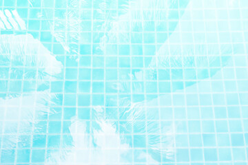 Abstract blurred coconut leaves shadow on swimming pool water, vintage filter, tropical concept background
