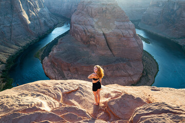 Woman on Grand canyon. Travel and active lifestyle. Girl enjoying view of Horseshoe bend.