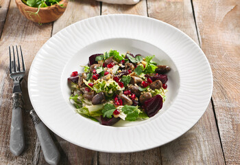 Warm Chicken Liver and Beet Salad. Restaurant food plate on wooden table. Vegetables, healthy, organic food concept