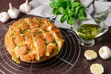 Garlic bread with different herbs on dark background