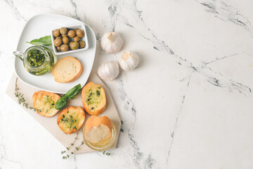 Composition with fresh bread and different spices on light background
