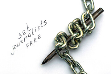 a fountain pen wrapped in an iron chain on sheets of white paper with the inscription set...