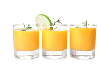 Glasses of tasty mango smoothie on white background