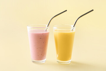 Glasses of tasty fruit and berry smoothie on color background