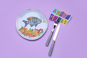 Plate with paper fish on color background. April Fools Day celebration