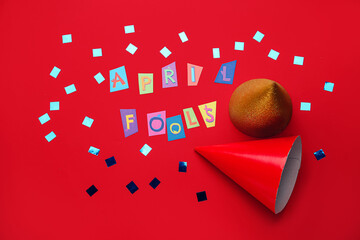 Party hats and text APRIL FOOLS on color background