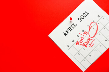 Calendar with marked date of April Fool's Day on color background