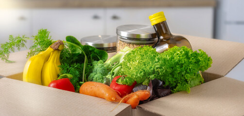 Food delivery or donation concept. Full box of food in the kitchen close up
