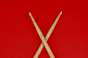 Crossed xylophone
mallets on a red background.