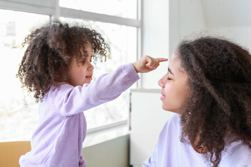 Cute African-American sisters at home