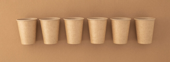 Zero waste,  plastic free concept. Disposable paper cups on beige background top view. Eco sustainable living