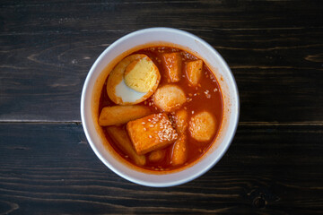 Stir-fried Rice Cake Tteok-bokki in a takeaway container. Korean food delivery.