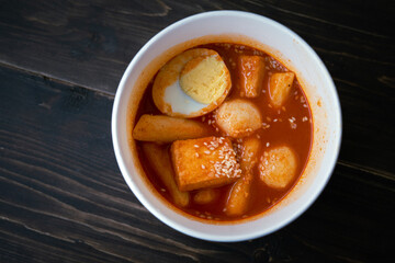 Stir-fried Rice Cake Tteok-bokki in a takeaway container. Korean food delivery.