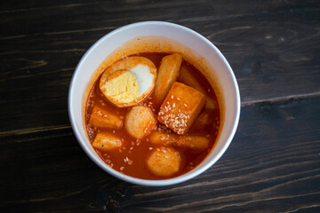 Stir-fried Rice Cake Tteok-bokki in a takeaway container. Korean food delivery.