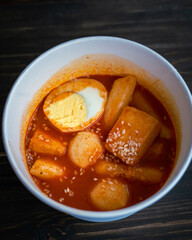 Stir-fried Rice Cake Tteok-bokki in a takeaway container. Korean food delivery.