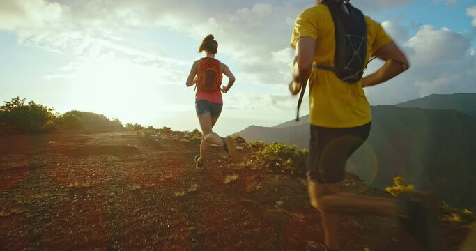 Running on mountain trail at sunset, epic adventure, healthy fitness lifestyle, training for marathon