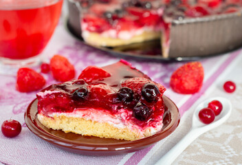 a piece of berry pie for breakfast closeup, a cake decorated with strawberries and black currants in jelly, healthy nutrition, side view of vegan dessert