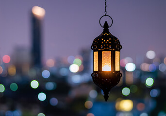 Hanging lantern with night sky and city bokeh light background for the Muslim feast of the holy month of Ramadan Kareem.