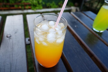 Summer fresh cold drink beverages. Ice Lemonade, orange juice and spirits in glasses  on the table outdoor. Refreshing cocktail. It is called 