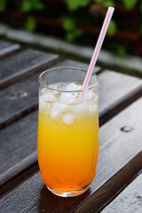 Summer fresh cold drink beverages. Ice Lemonade, orange juice and spirits in glasses  on the table outdoor. Refreshing cocktail. It is called 
