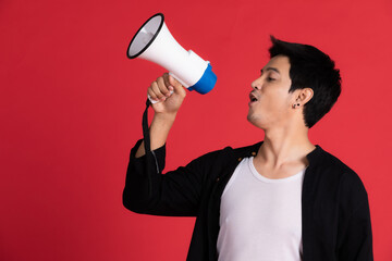 Asian men in black shirts are using the bullhorn to spread the sound. On a red background