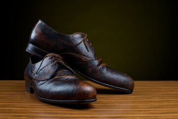 Piton leather man's n shoes on black background