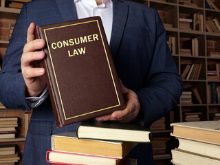 Attorney holds CONSUMER LAW book.  Consumer protection measures are often established by law