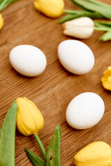 chicken eggs bouquet flowers wooden background close-up easter