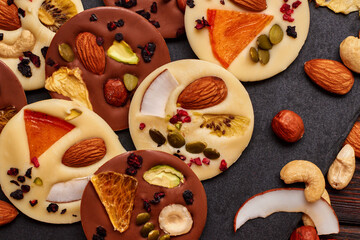 Handmade milk and white chocolate with dried fruits and nuts