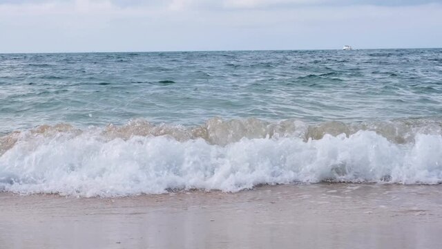 Image of a crashing wave on the blue sea.