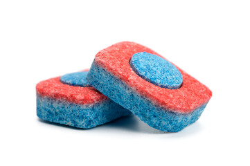 two dishwasher tablets close up on a white isolated background