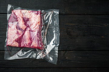 Vide sous vacuum beef brisket food, on black wooden table background, top view flat lay , with copyspace  and space for text