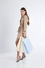 Feminine brunette with colorful shopping bags.