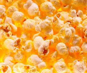 Pile of fresh popcorn filling the frame against bright light