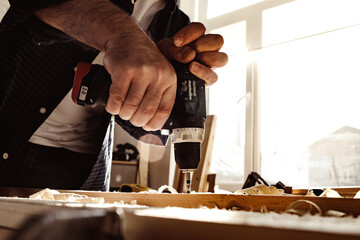Close up of a carpenter drilling a hole in timber