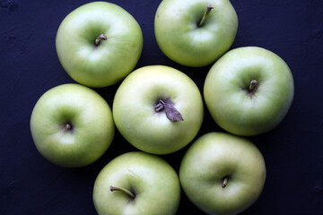 Juicy yellow apples on a black background.