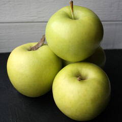 Juicy yellow apples on a black background.