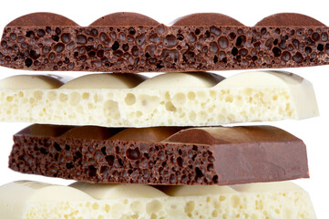 Stack of brown and white porous chocolate isolated on the white background