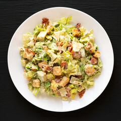 Homemade Bacon Avocado Caesar Salad with Cheese and Croutons, top view. Flat lay, overhead, from above.