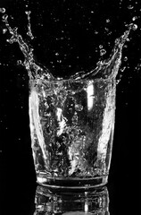 water splash in glass, isolated on black