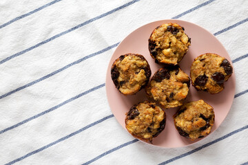 Homemade Chocolate Banana Bread Pudding on a pink plate, top view. Flat lay, overhead, from above. Copy space.