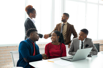 team of young african people in the office at the table with a laptop 