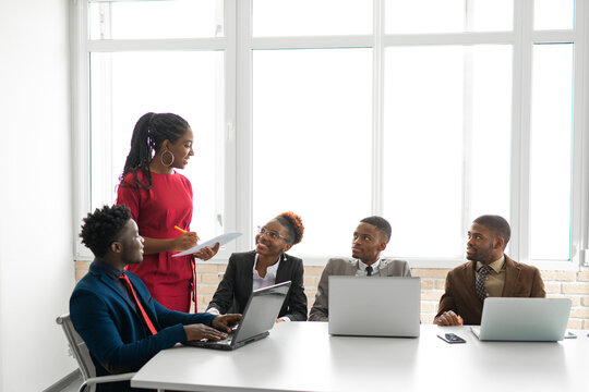 Team Of Young African People In The Office At The Table With A Laptop 