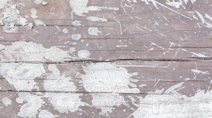 Drops and splashes from concrete on a wooden board