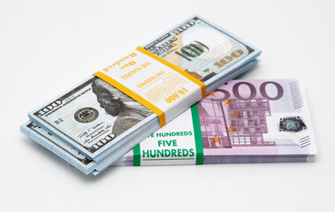 Fototapeta premium Bundle of dollars and euros on a white