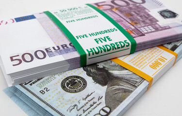Bundle of dollars and euros on a white