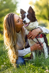 Beautiful woman walking, playing with a cute dog in nature © NDABCREATIVITY